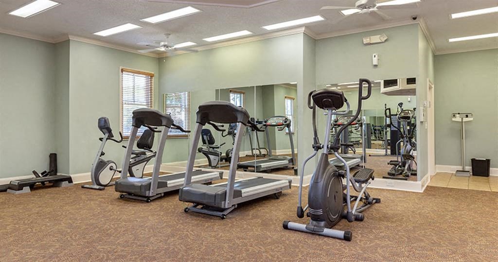 a gym with various exercise bikes and weights a gym with various exercise bikes and weights at Bedford Parke Apartments, Georgia, 31088