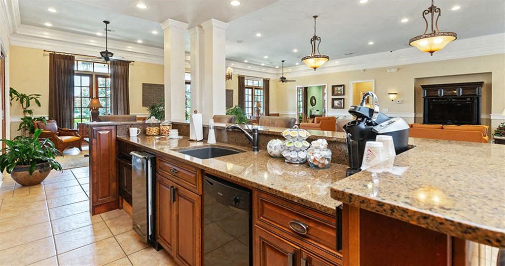 a large kitchen with a sink and a counter top at Bedford Parke Apartments, Warner Robins, GA