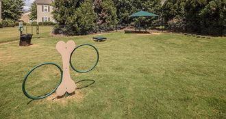 a park with a tennis racket and a hoop at Bedford Parke Apartments, Warner Robins, GA 31088