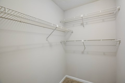 Empty white shelves in a room.