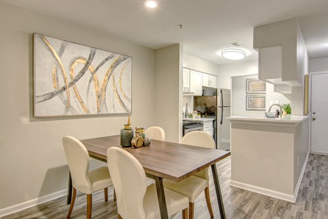 an open kitchen and dining room with a table and chairs