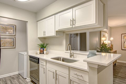 a kitchen with white cabinets and a sink