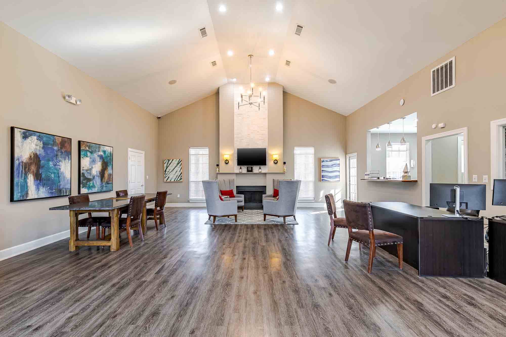 A spacious living room with a fireplace and a dining table set up.