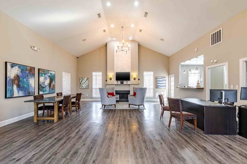 A spacious living room with a fireplace and a dining table set up.