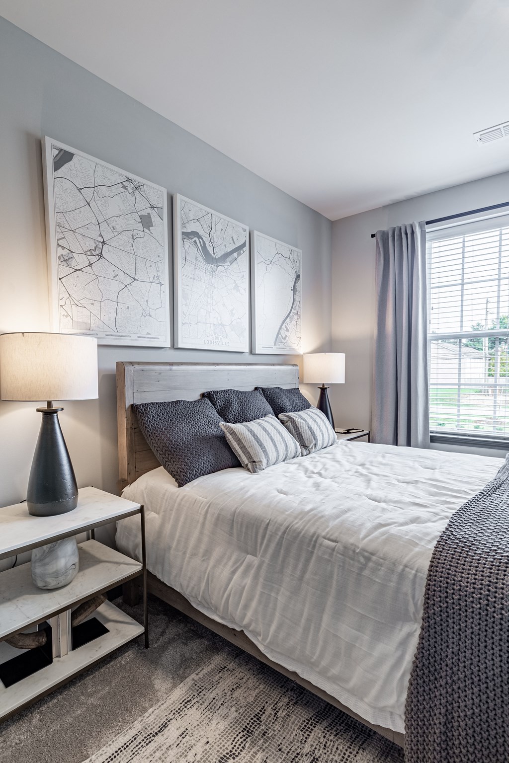 a bedroom with a large bed and a window at The Louis Apartment Flats, Louisville