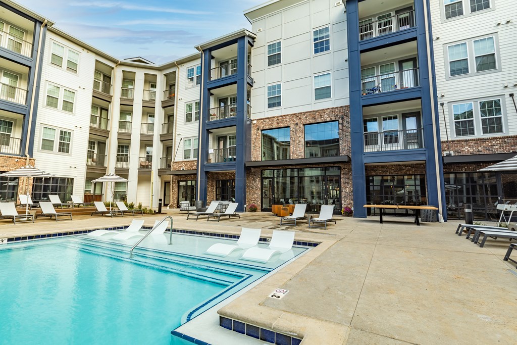 a swimming pool in front of an apartment building at The Louis Apartment Flats, Kentucky