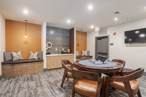 A modern dining room with a round table and chairs.