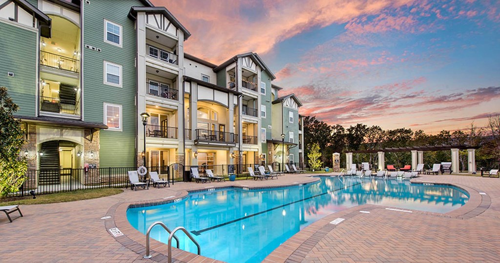 the pool at the residence apartment building at sunset