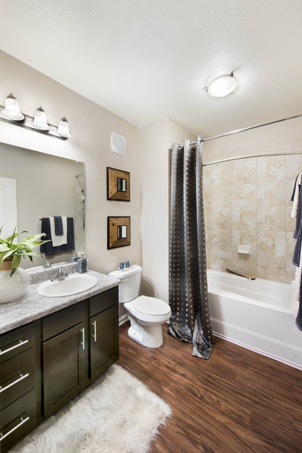 a bathroom with a shower toilet and sink and a bath tub