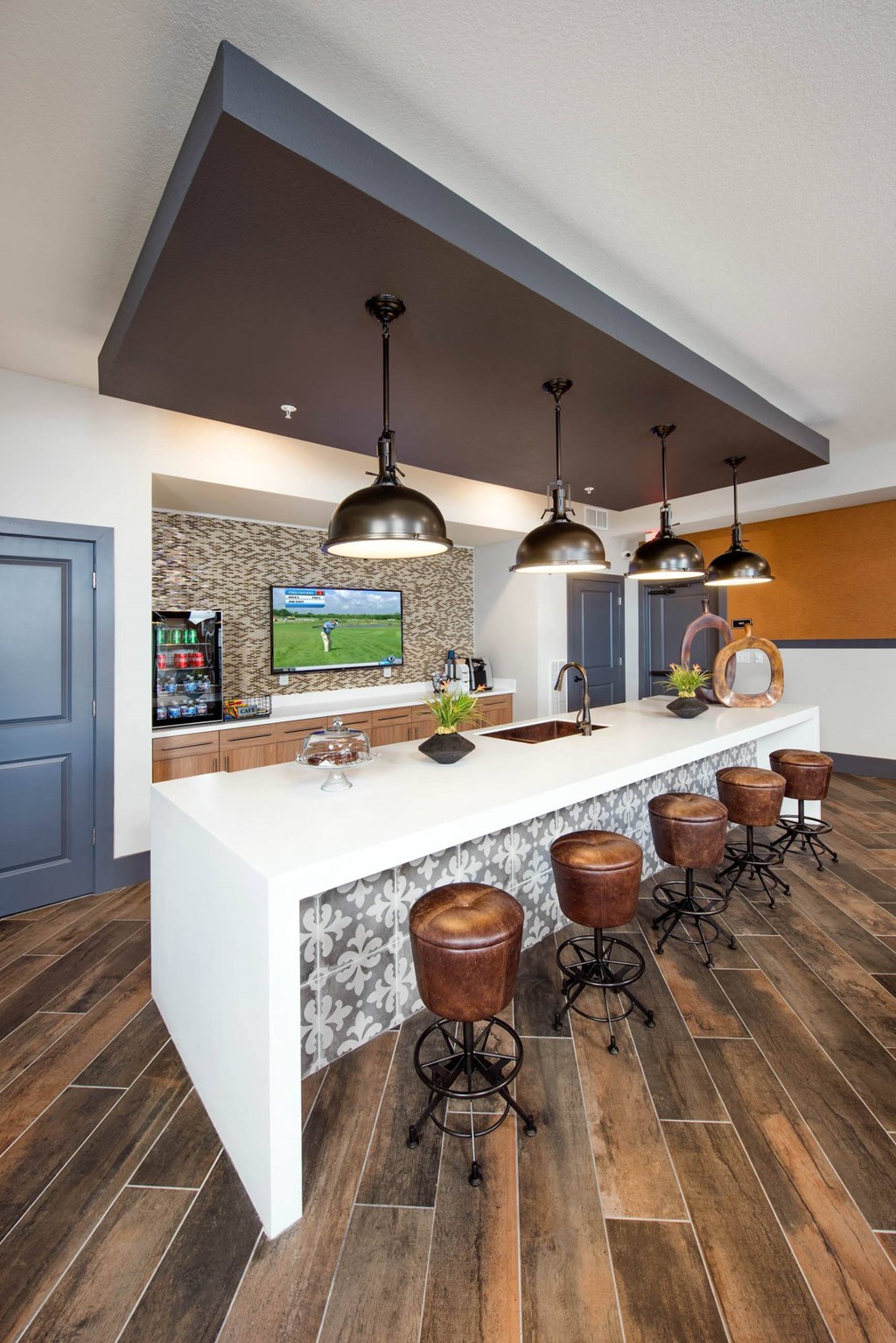 a kitchen with a long counter and stools