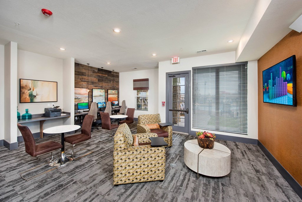 a living room with couches and chairs and a tv