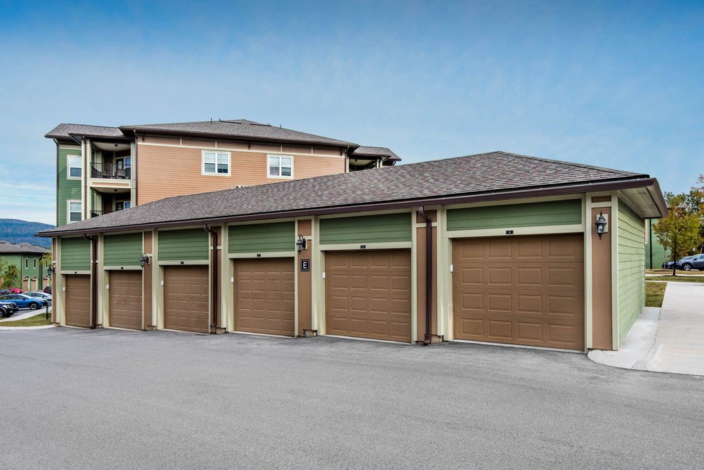 a row of garage doors in front of a house