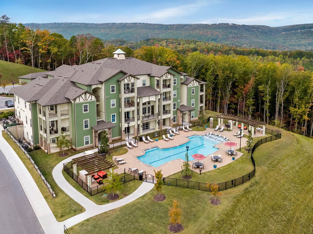an aerial view of a resort building with a swimming pool