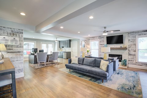 A modern living room with a grey sofa and a fireplace.