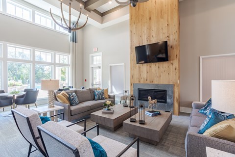 A living room with a fireplace and a television mounted on the wall.