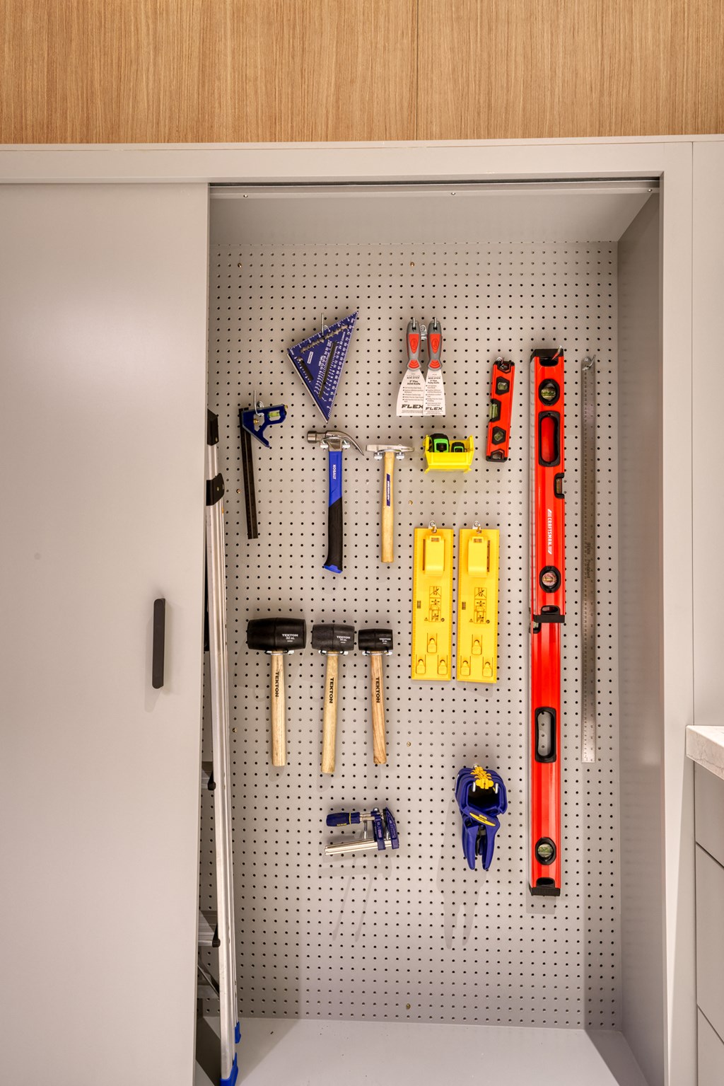 a pegboard wall in a kitchen with tools on it at Lyric at Norton Commons Apartments, Prospect, KY
