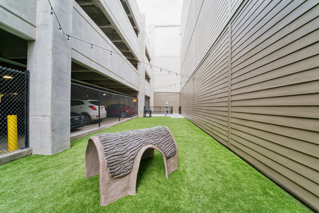 a wooden bench in the grass next to a building at Lyric at Norton Commons Apartments, Prospect, Kentucky