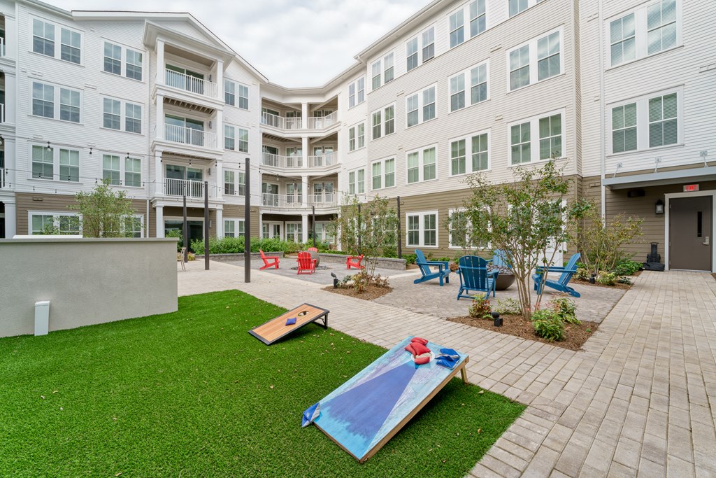 a courtyard with a surfboard in front of an apartment building at Lyric at Norton Commons Apartments, Prospect, KY