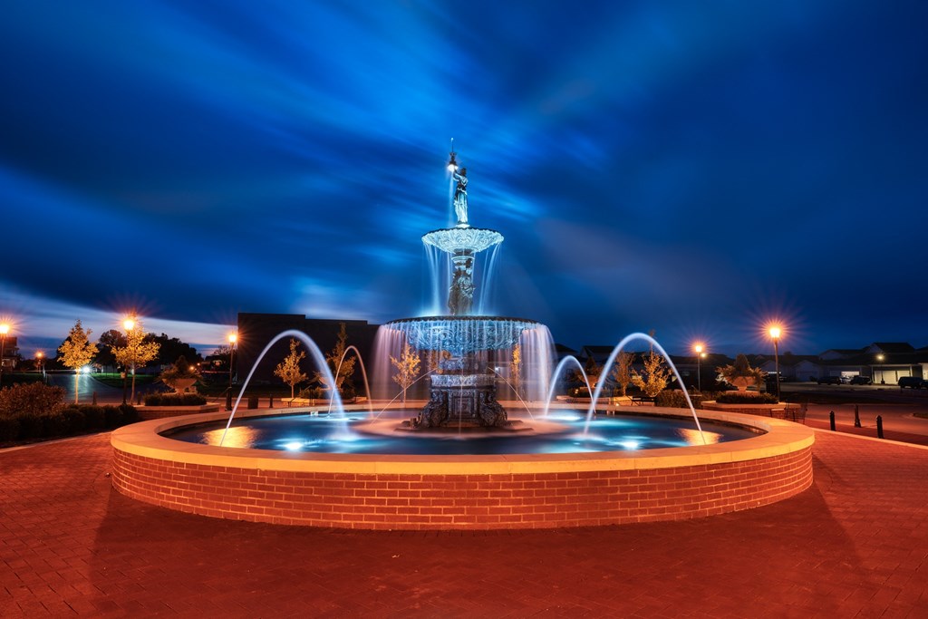 a fountain in a park at night at Lyric at Norton Commons Apartments, Prospect, 40059