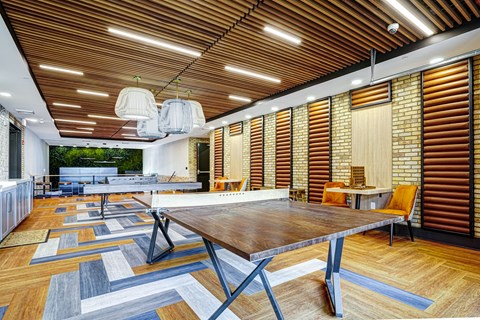A modern dining room with a wooden table and chairs.