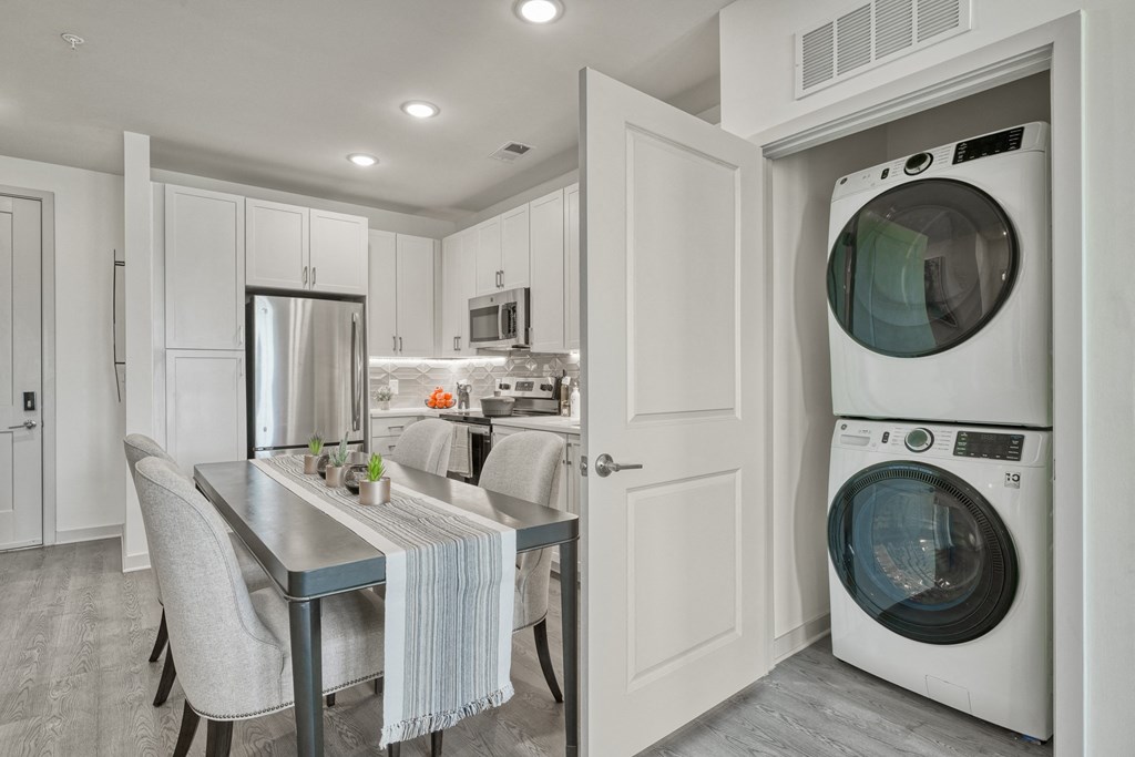 a white laundry room with a washing machine and a sink at Lyric at Norton Commons Apartments, Prospect, Kentucky