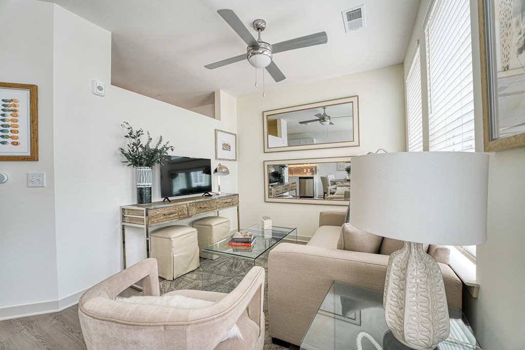 a living room with a ceiling fan and a glass table at Lyric at Norton Commons Apartments, Prospect, KY