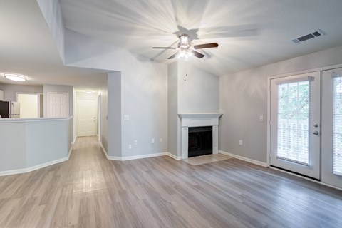 A spacious living room with a fireplace and sliding glass doors.