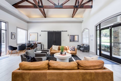 A living room with a brown couch and a white coffee table.