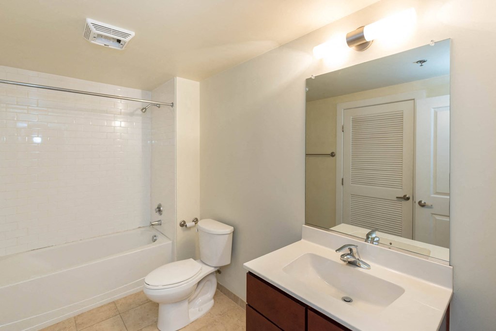 a bathroom with a sink toilet and a bath tub at Mayton Transfer Lofts, Virginia