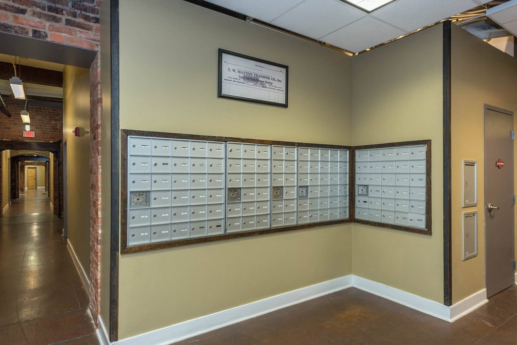 a wall with mailboxes on it in a hallway at Mayton Transfer Lofts, Petersburg Virginia