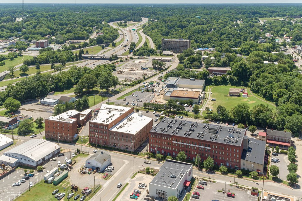 an aerial view of a city with buildings and trees at Mayton Transfer Lofts, Petersburg, VA 23803