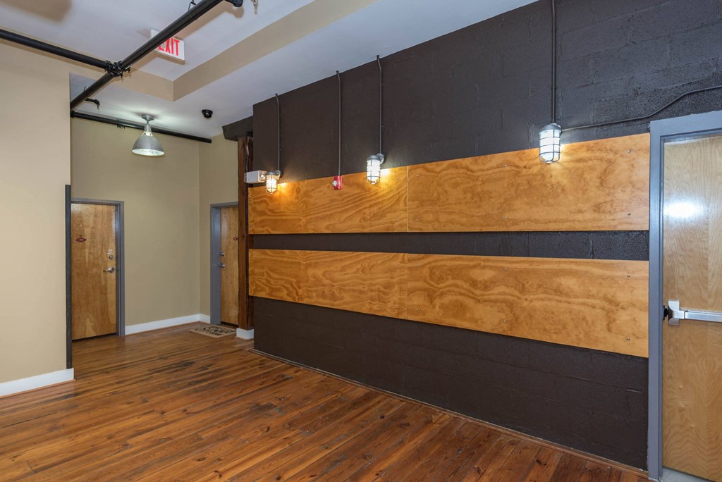 a large room with wood floors and a wooden wall at Mayton Transfer Lofts, Virginia