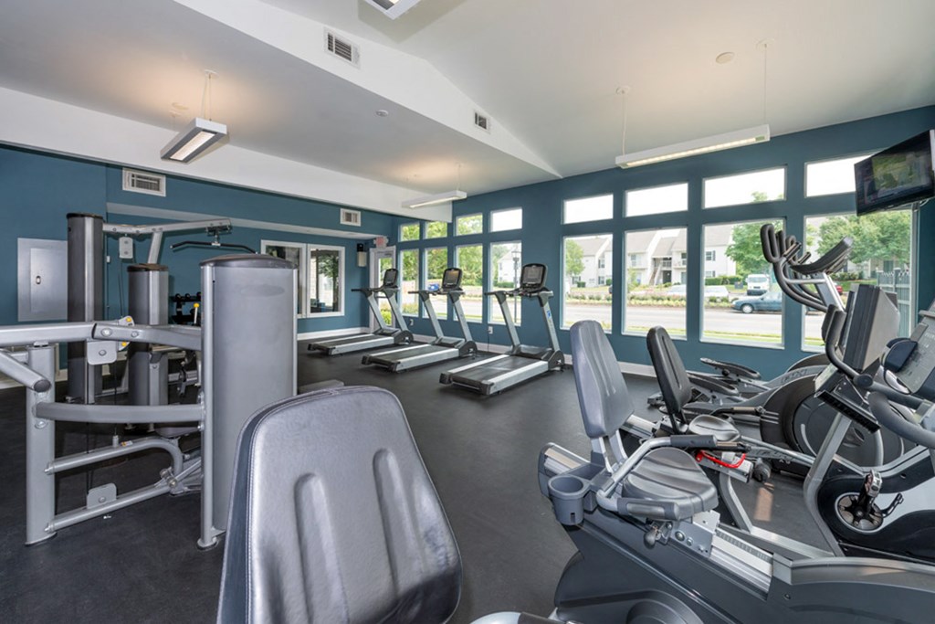 a gym with cardio equipment and windows at Misty Ridge Apartments, Woodbridge, 22191