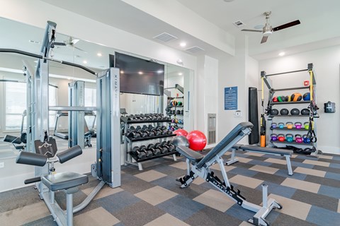 A gym with a variety of equipment including a leg press machine.
