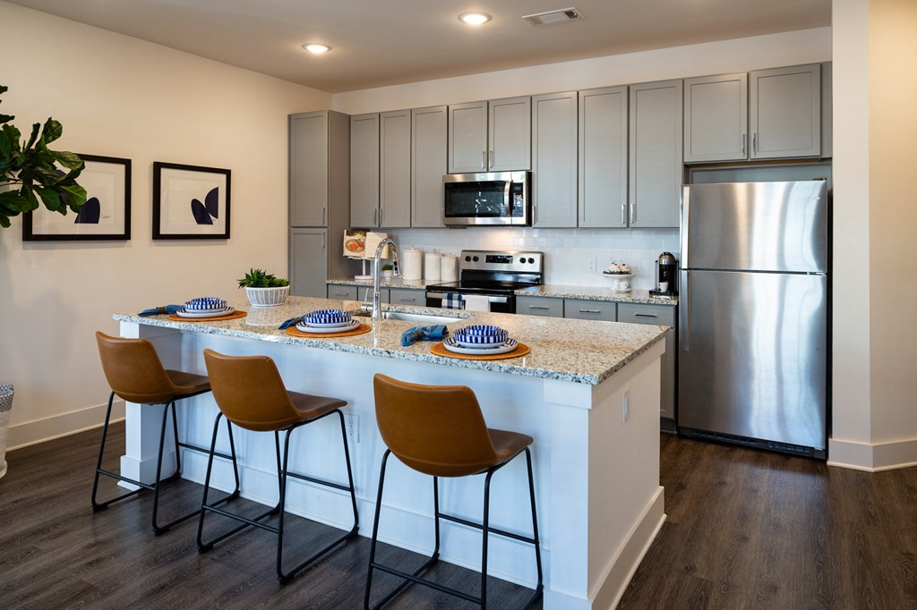 a view of a kitchen with a bunch of stars on the wall at The Quincy Apartments, Acworth, 30102