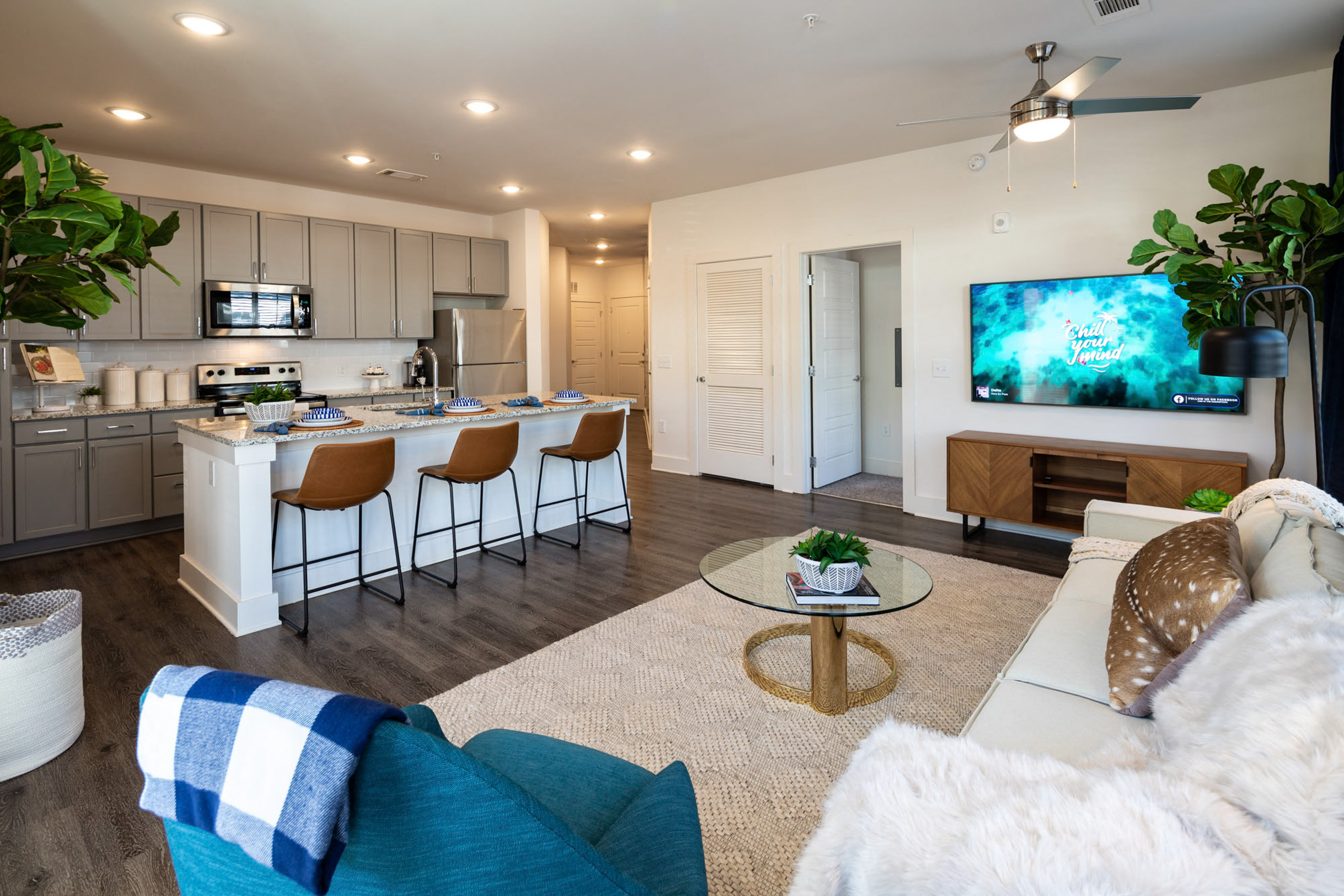 a living room and kitchen with a couch and a table