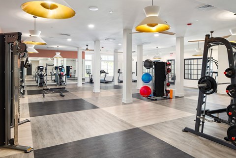 a gym with colorful lights on the ceiling at The Quincy Apartments, Georgia, 30102