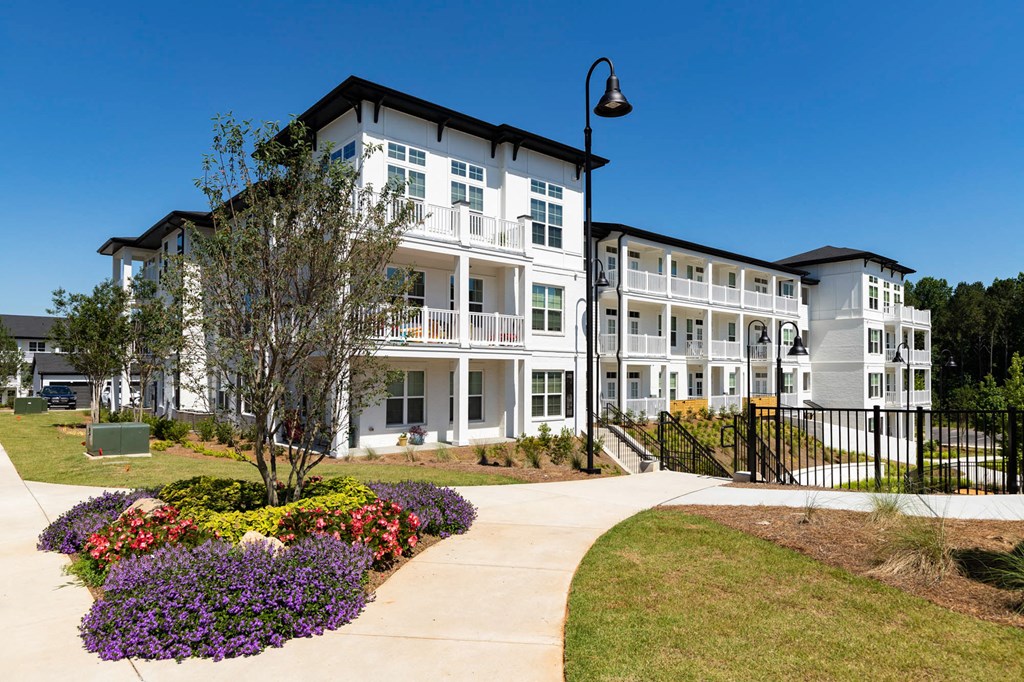 a sidewalk in front of an apartment building at The Quincy Apartments, Georgia, 30102