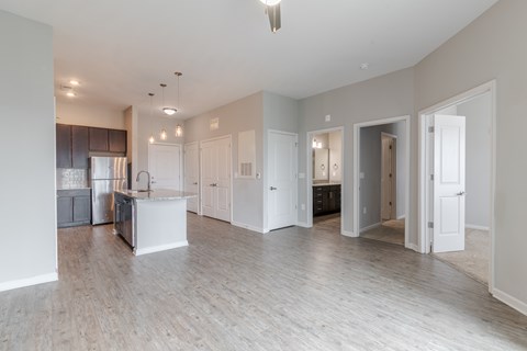 A spacious kitchen with a refrigerator, sink, and cabinets.