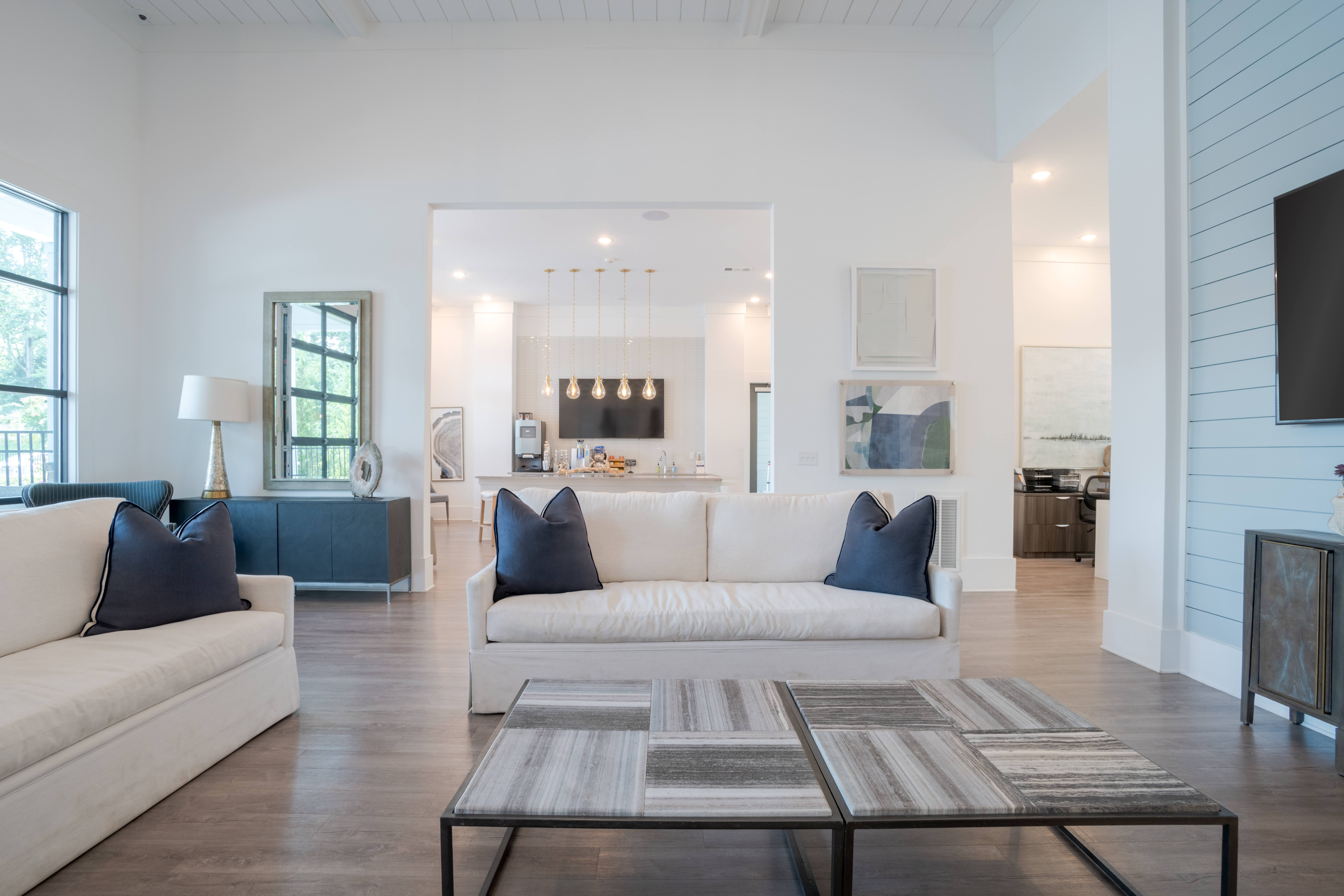A modern living room with a white couch and a coffee table.