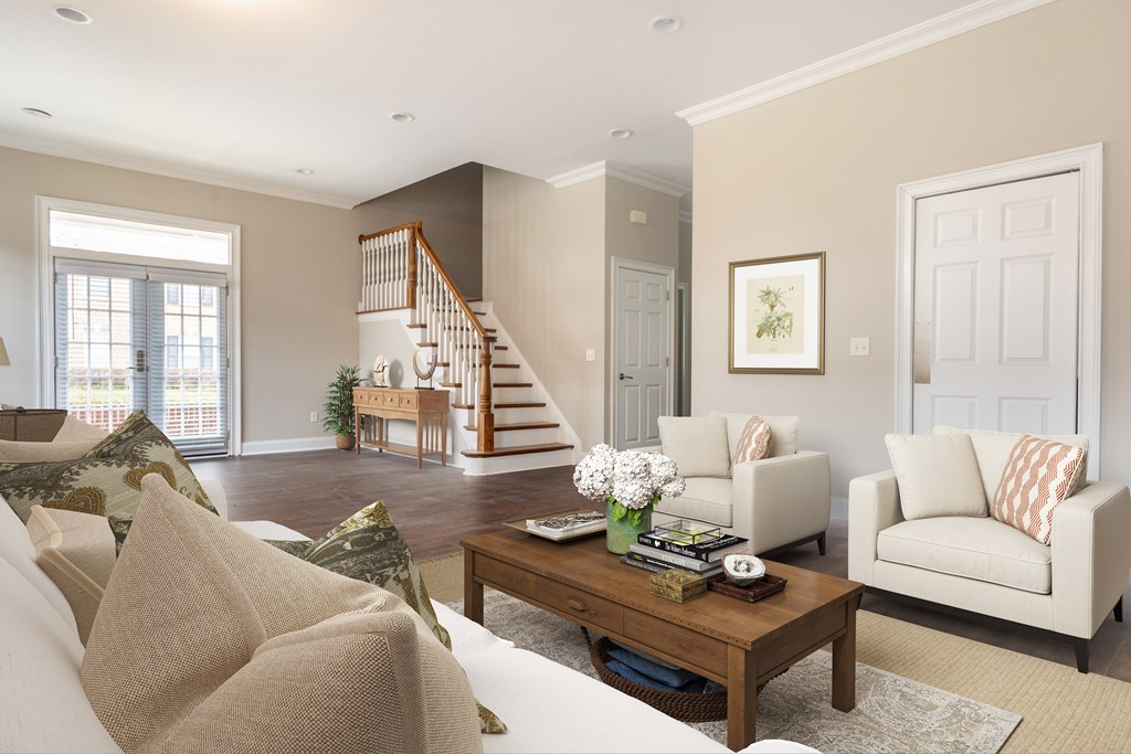 A living room with a staircase and a couch  at Sterling Manor, Williamsburg, VA, 23185