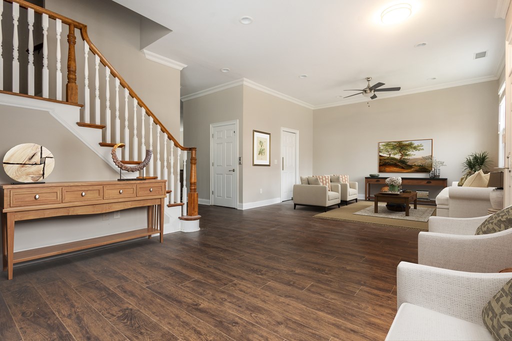 A living room with a staircase and a ceiling fan  at Sterling Manor, Williamsburg, Virginia