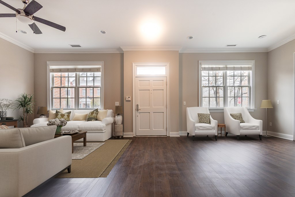 A living room with a white couch, two chairs, and a ceiling fan  at Sterling Manor, Williamsburg, Virginia