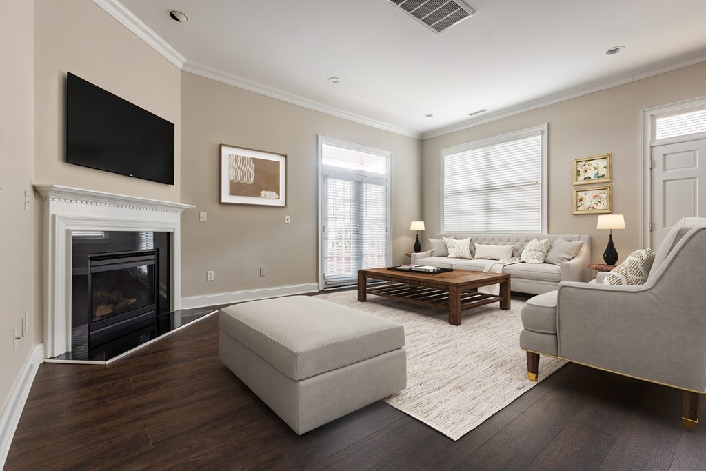 A living room with a fireplace and a flat screen TV mounted on the wall  at Sterling Manor, Williamsburg, VA