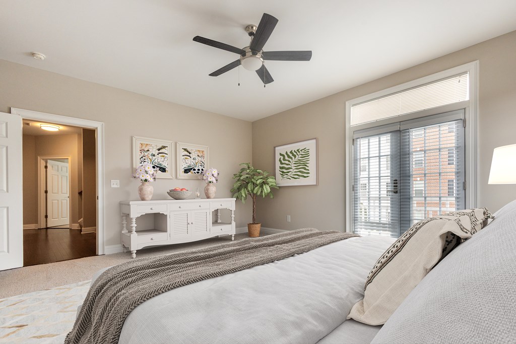 A bedroom with a large bed and a ceiling fan  at Sterling Manor, Williamsburg, 23185