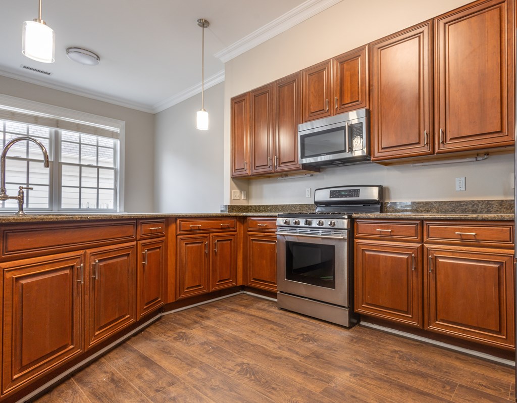 A kitchen with wooden cabinets and a stainless steel oven  at Sterling Manor, Williamsburg, Virginia