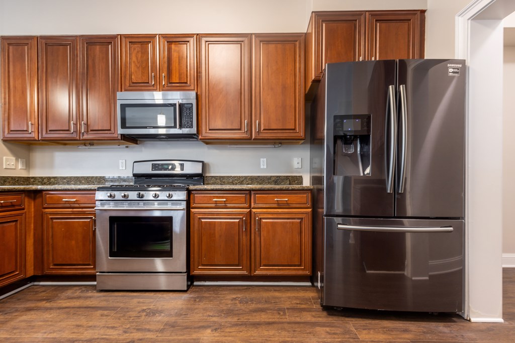 A kitchen with a stainless steel refrigerator, oven, and microwave  at Sterling Manor, Williamsburg, VA, 23185