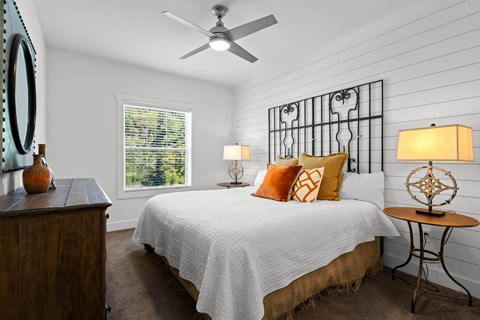 a bedroom with a bed and a ceiling fan