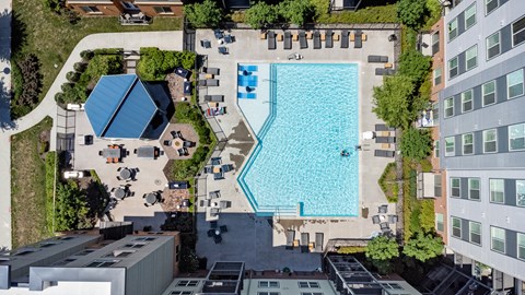 an aerial view of a large swimming pool surrounded by buildings and trees at Rivergate, Virginia, 22191
