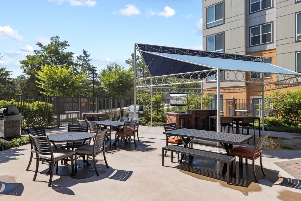 a patio with tables and chairs and a grill at Rivergate, Woodbridge, VA, 22191